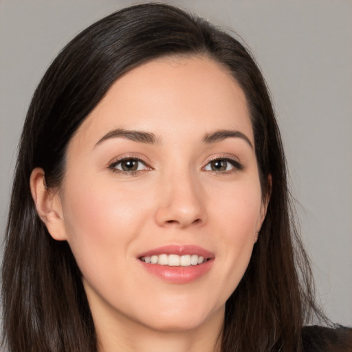 Joyful white young-adult female with long  brown hair and brown eyes