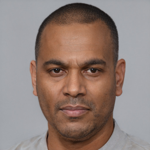 Neutral latino adult male with short  black hair and brown eyes