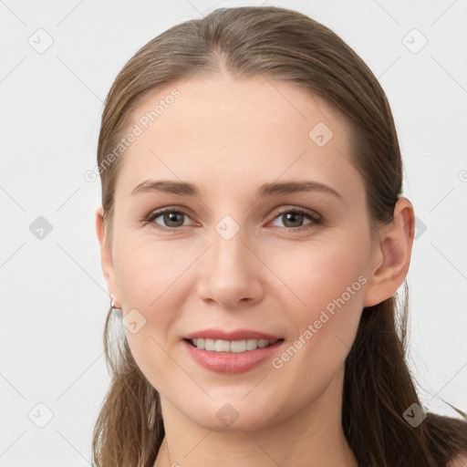 Joyful white young-adult female with long  brown hair and grey eyes