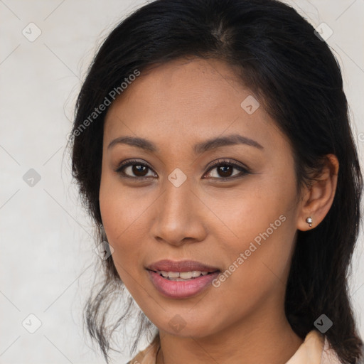 Joyful latino young-adult female with long  brown hair and brown eyes