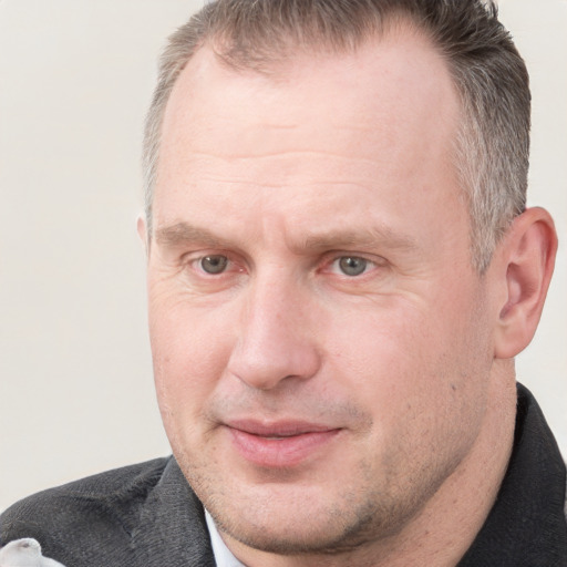 Joyful white adult male with short  brown hair and grey eyes