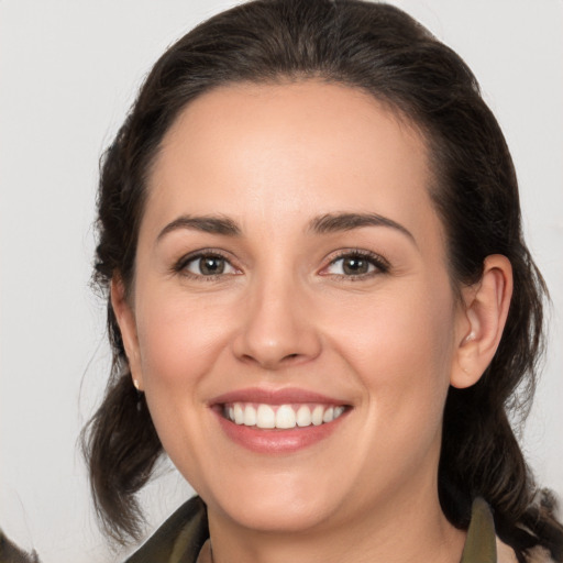 Joyful white young-adult female with medium  brown hair and brown eyes