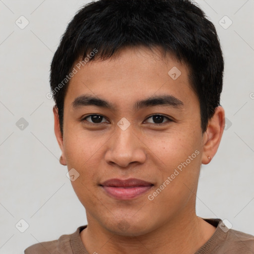 Joyful asian young-adult male with short  brown hair and brown eyes