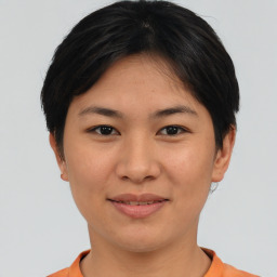 Joyful asian young-adult female with short  black hair and brown eyes