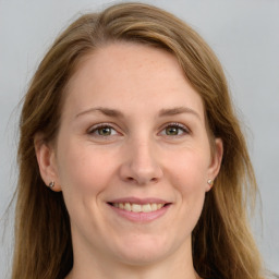 Joyful white adult female with long  brown hair and grey eyes