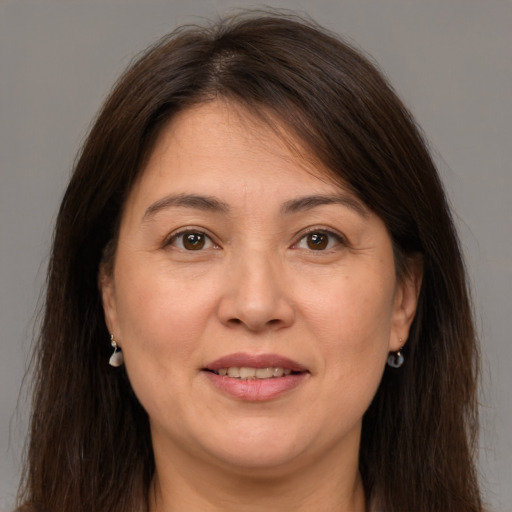 Joyful white adult female with long  brown hair and brown eyes