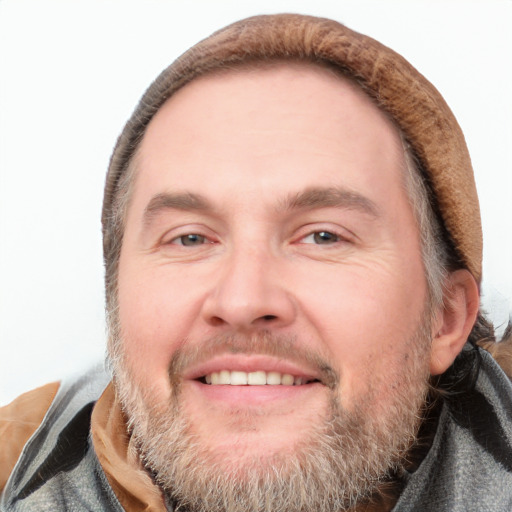 Joyful white adult male with short  brown hair and grey eyes