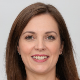 Joyful white adult female with long  brown hair and grey eyes