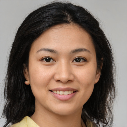 Joyful asian young-adult female with medium  brown hair and brown eyes