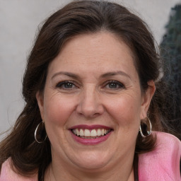 Joyful white adult female with medium  brown hair and brown eyes