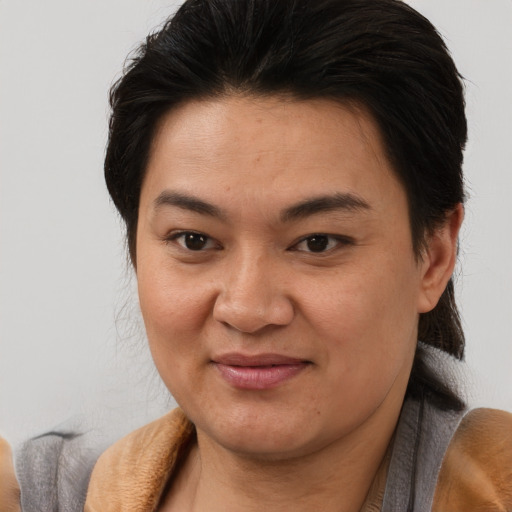 Joyful asian young-adult female with medium  brown hair and brown eyes