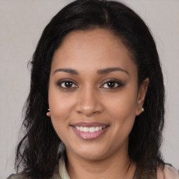 Joyful black young-adult female with long  brown hair and brown eyes