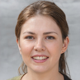 Joyful white young-adult female with medium  brown hair and grey eyes