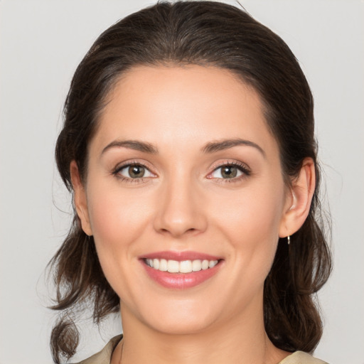 Joyful white young-adult female with medium  brown hair and brown eyes