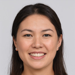 Joyful white young-adult female with long  brown hair and brown eyes