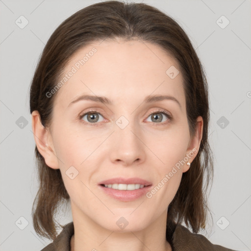 Joyful white young-adult female with medium  brown hair and grey eyes