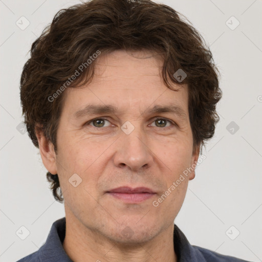 Joyful white adult male with short  brown hair and grey eyes