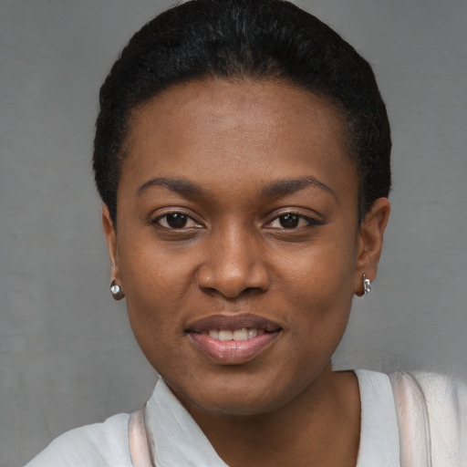 Joyful black young-adult female with short  black hair and brown eyes
