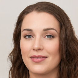 Joyful white young-adult female with long  brown hair and green eyes