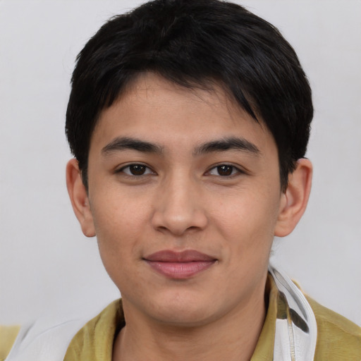 Joyful asian young-adult male with short  black hair and brown eyes