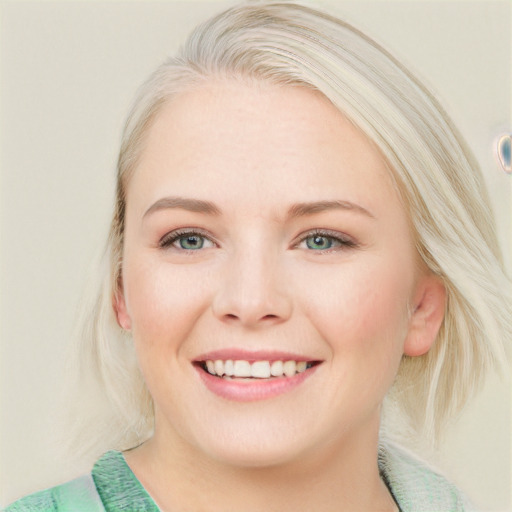 Joyful white young-adult female with medium  blond hair and blue eyes