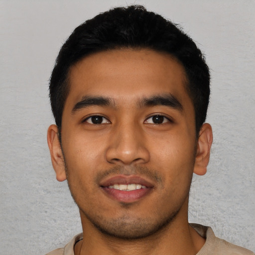 Joyful asian young-adult male with short  black hair and brown eyes