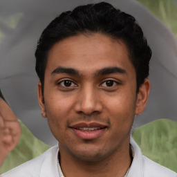 Joyful latino young-adult male with short  black hair and brown eyes