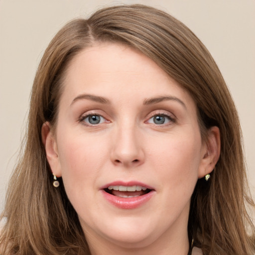 Joyful white young-adult female with long  brown hair and grey eyes