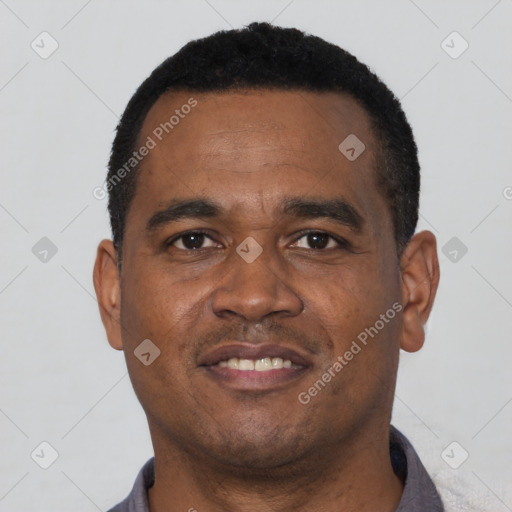 Joyful black young-adult male with short  black hair and brown eyes