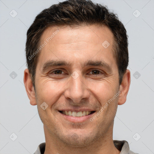 Joyful white adult male with short  brown hair and brown eyes