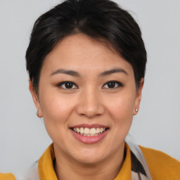 Joyful asian young-adult female with short  brown hair and brown eyes