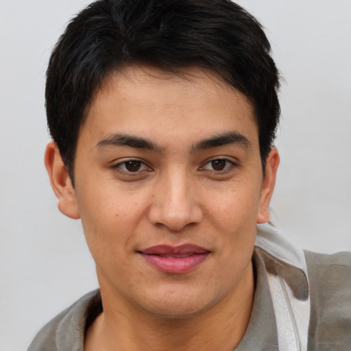 Joyful latino young-adult male with short  brown hair and brown eyes