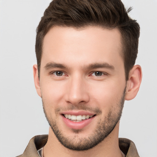 Joyful white young-adult male with short  brown hair and brown eyes