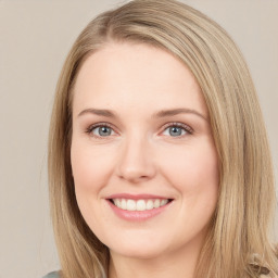 Joyful white young-adult female with long  brown hair and green eyes