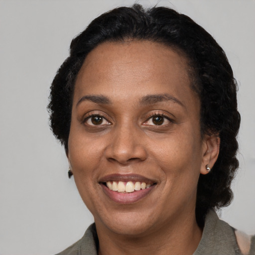 Joyful latino adult female with short  black hair and brown eyes