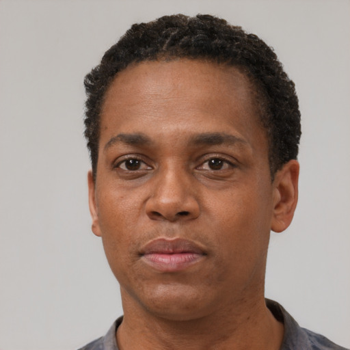 Neutral black adult male with short  black hair and brown eyes