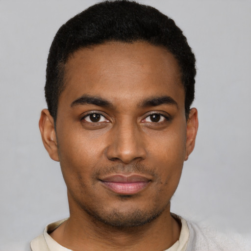 Joyful black young-adult male with short  black hair and brown eyes