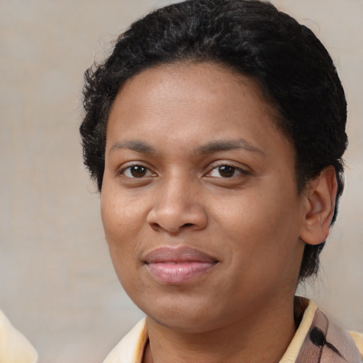 Joyful black young-adult female with medium  brown hair and brown eyes