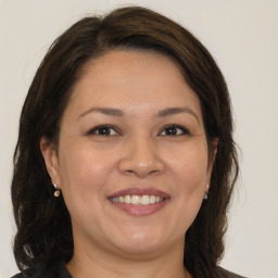 Joyful white adult female with medium  brown hair and brown eyes