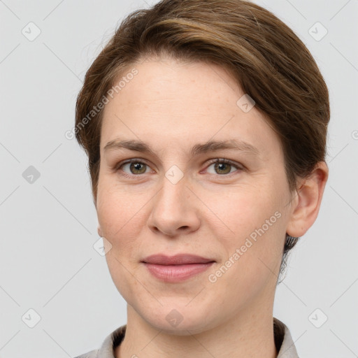 Joyful white young-adult female with short  brown hair and grey eyes