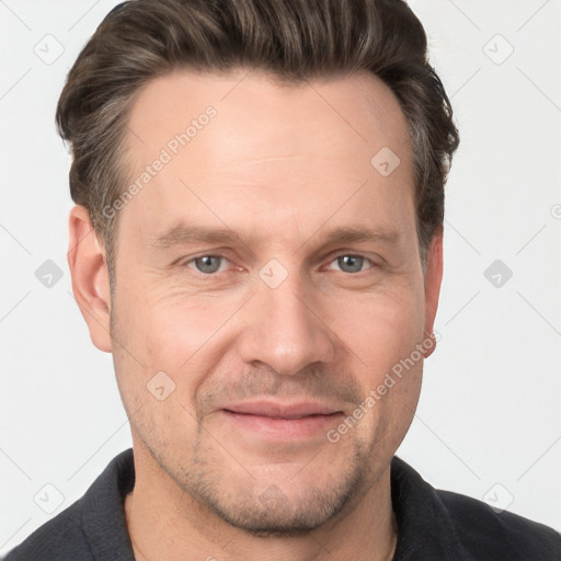 Joyful white adult male with short  brown hair and grey eyes