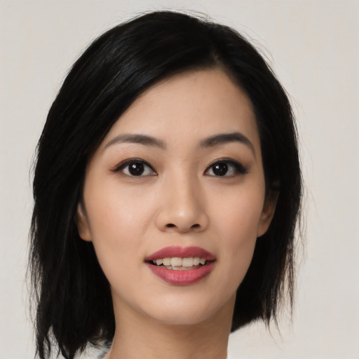 Joyful asian young-adult female with medium  black hair and brown eyes