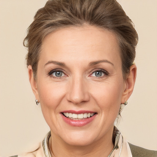 Joyful white adult female with short  brown hair and grey eyes