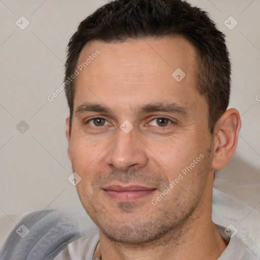 Joyful white adult male with short  brown hair and brown eyes