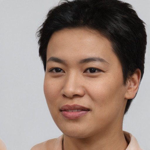 Joyful asian young-adult female with short  black hair and brown eyes