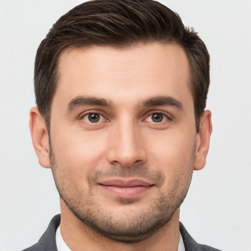 Joyful white young-adult male with short  brown hair and brown eyes