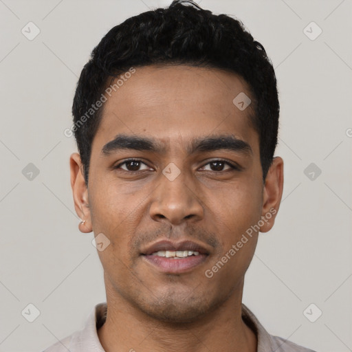 Joyful latino young-adult male with short  black hair and brown eyes