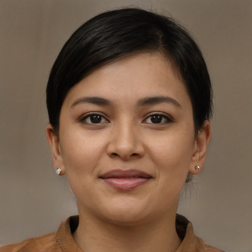 Joyful latino young-adult female with short  brown hair and brown eyes