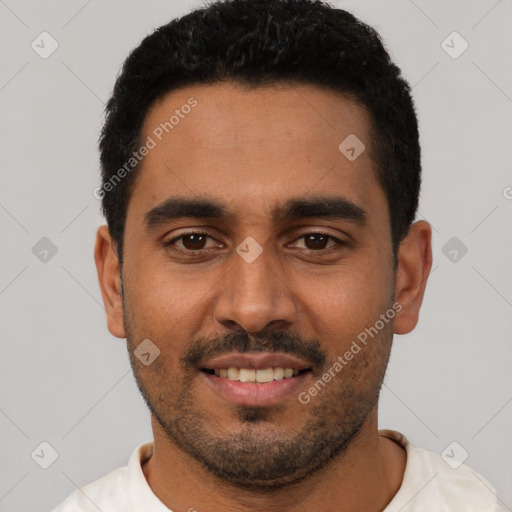 Joyful black young-adult male with short  black hair and brown eyes