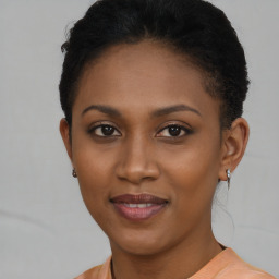 Joyful black young-adult female with short  brown hair and brown eyes
